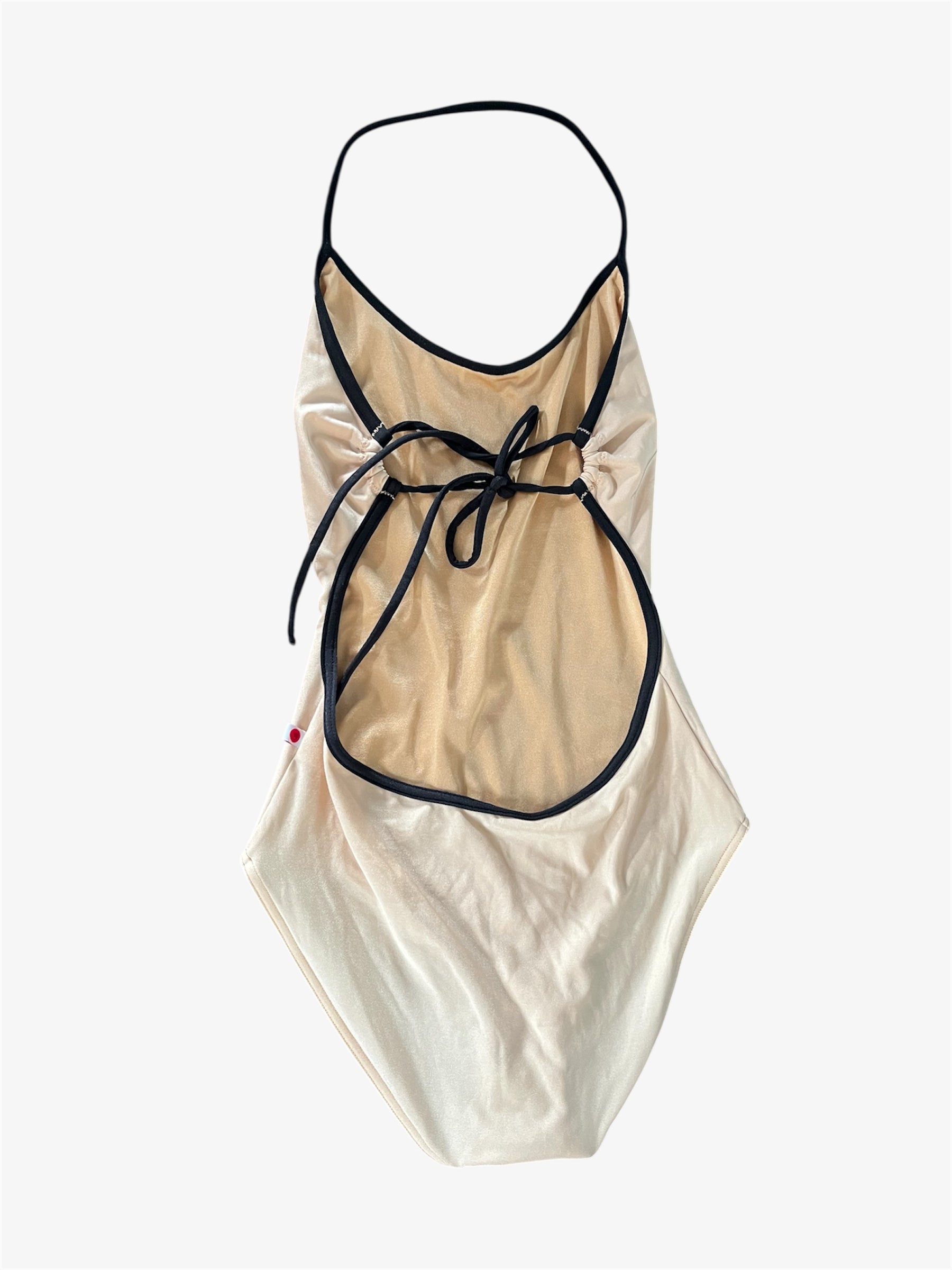 Beige leotard with black trim on a white background
