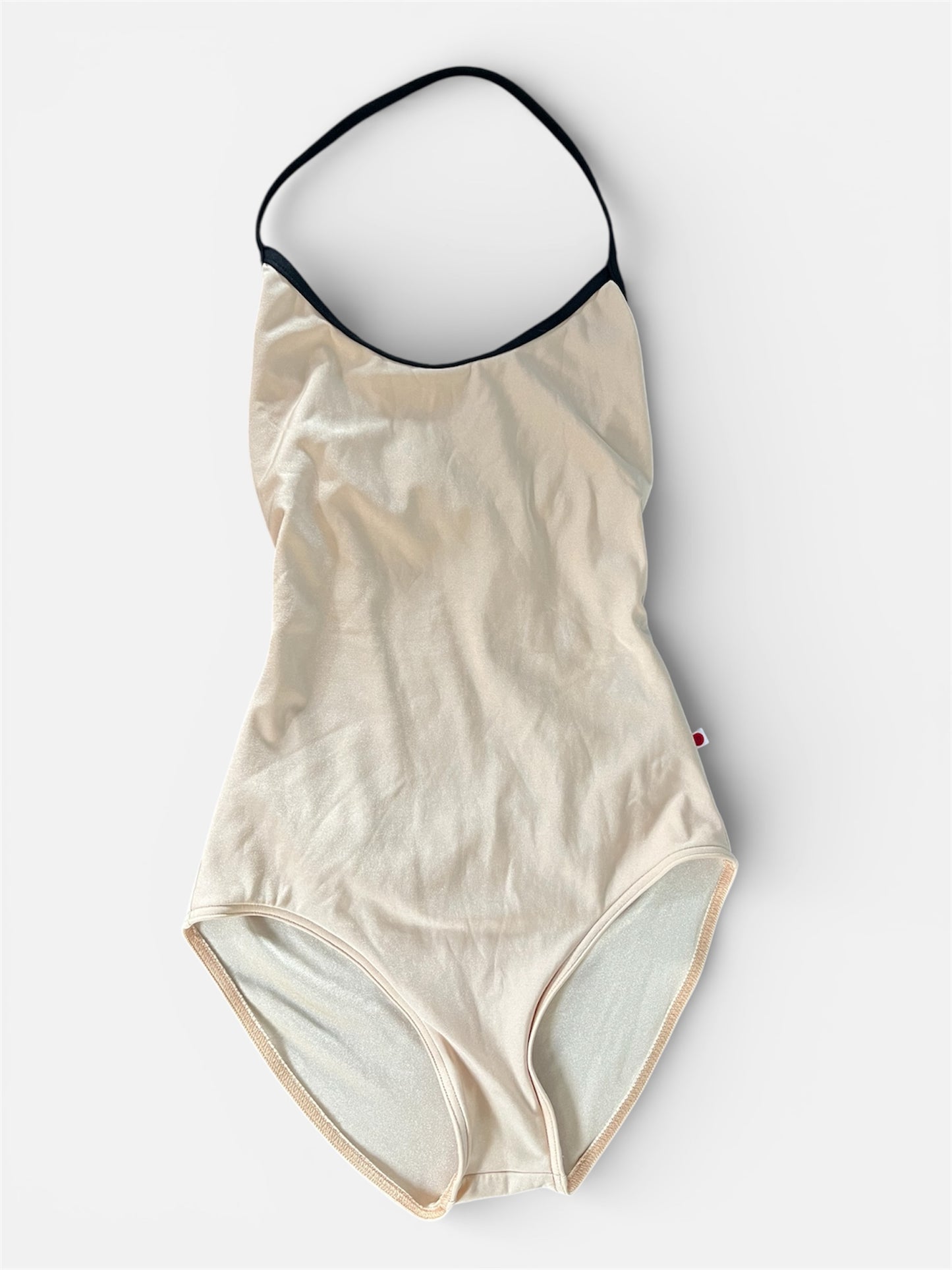 Beige leotard with black trim on a white background